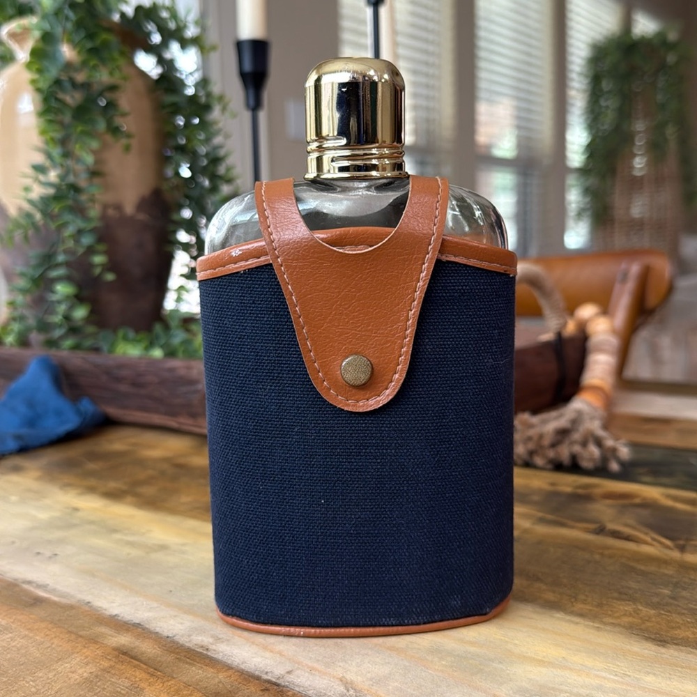 Vintage Swank glass flask with a leather navy blue strap